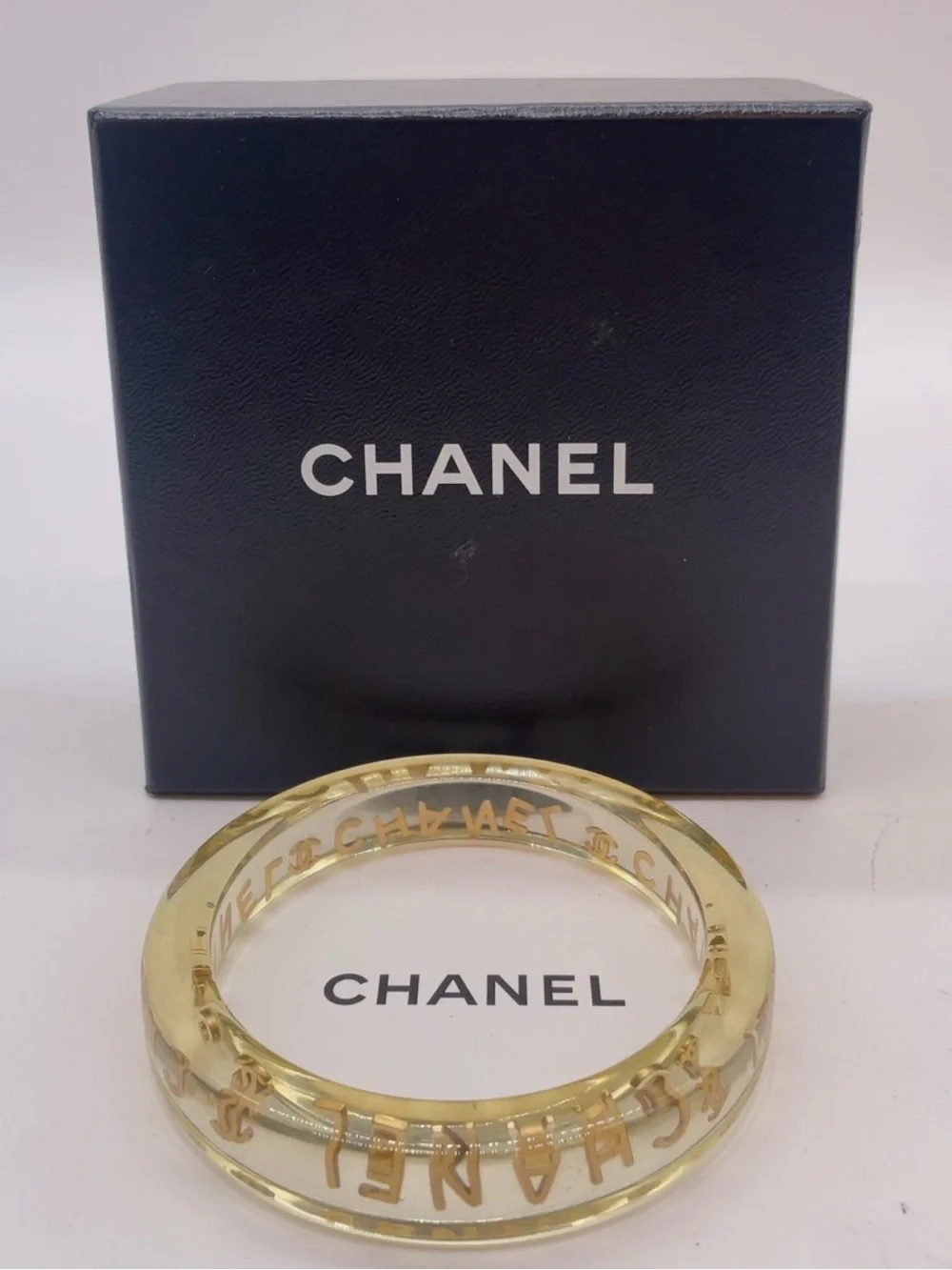 CHANEL LUCITE & Gold Letter Clear Acrylic Bangle - Picture 1 of 12